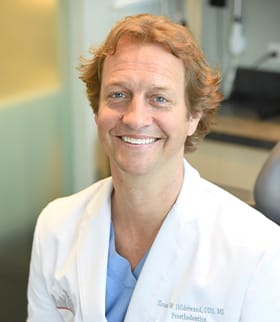 Dr. Sloan W. Hildebrand in his white clinic coat