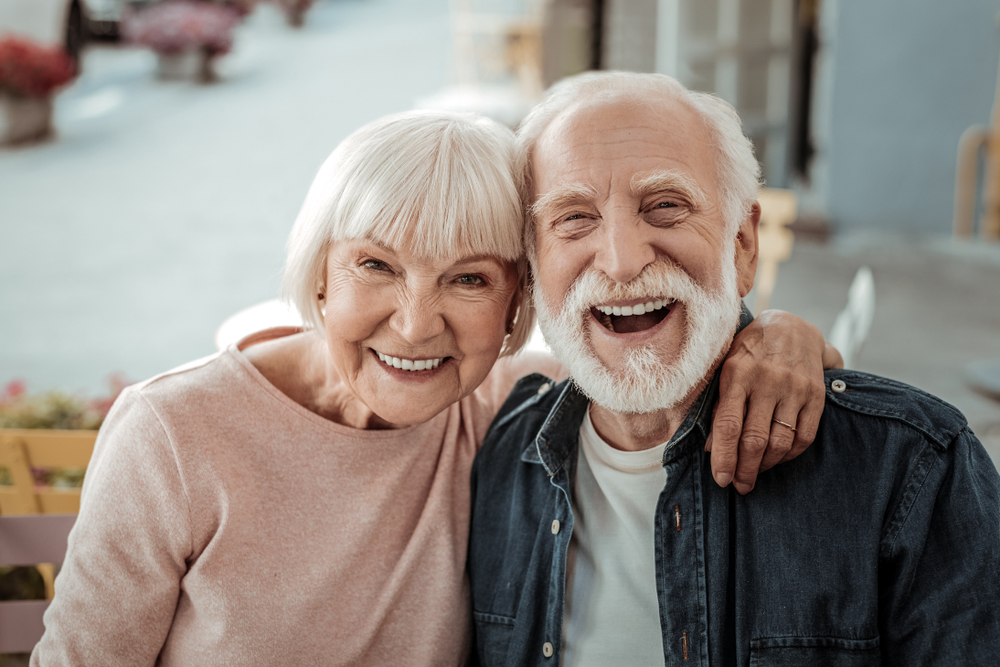 Smiling older couple sitting close together