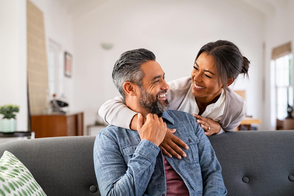 Smiling couple relaxing on a sofa at home