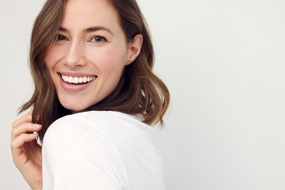 Smiling woman with wavy brown hair