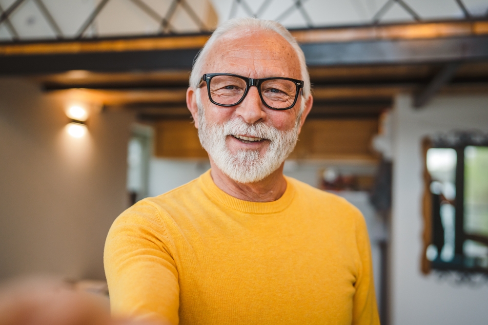 Smiling older man with glasses and a white beard