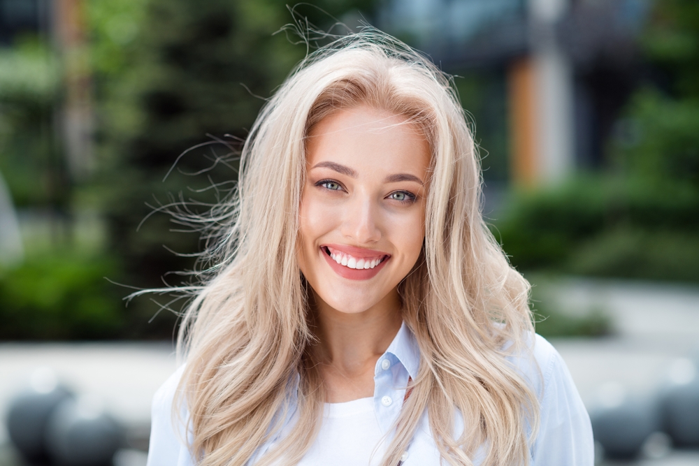 Smiling young woman with long blonde hair